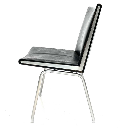 517 - After Hans J Wegner, a mid-century chrome-edged leather chair. Raised on a tubular metal frame. Heig... 