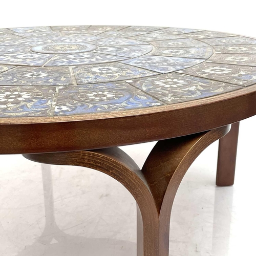 519 - A Danish circular coffee table with Royal Copenhagen Fajance tiles. Circa 1970s. With laminated bent... 