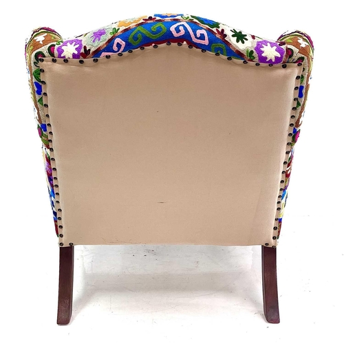 533 - An Ian Snow Ltd upholstered armchair. With Indian multi-coloured fabric upholstery on turned front l... 