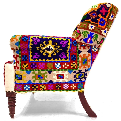 533 - An Ian Snow Ltd upholstered armchair. With Indian multi-coloured fabric upholstery on turned front l... 