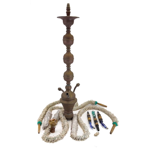 56 - A tall pierced Indian brass hookah. 20th century, with blue glass panels and three pipes, height 193... 