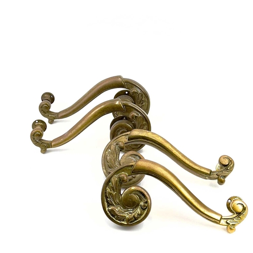 58 - Two pairs of brass theatre door handles. Circa 1900, with scrolled foliate terminals, height 30cm. T... 