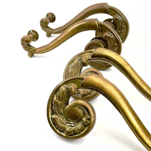 58 - Two pairs of brass theatre door handles. Circa 1900, with scrolled foliate terminals, height 30cm. T... 