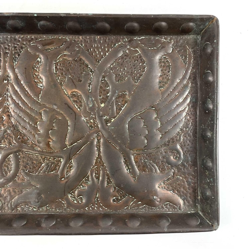 59 - An Arts & Crafts copper tray of rectangular form. Repousse decorated with a wyvern motif. 28cm x 56c... 