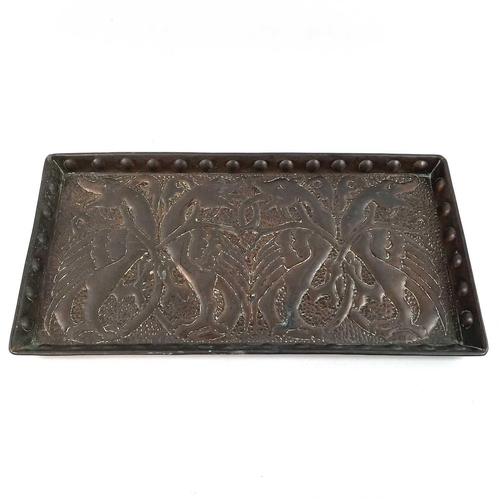 59 - An Arts & Crafts copper tray of rectangular form. Repousse decorated with a wyvern motif. 28cm x 56c... 