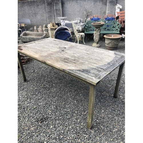 603 - A teak garden table. Height 75cm width 180cm depth 90cm.