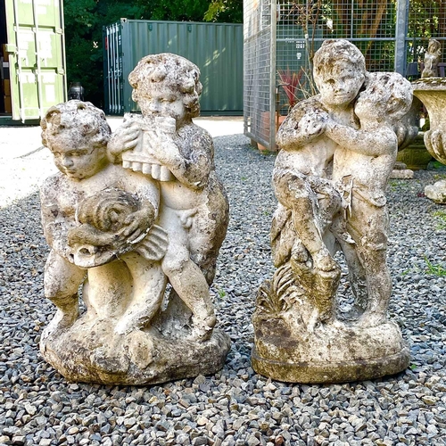 605 - A reconstituted stone fountain, modelled as putti playing pan pipes. Height 55cm together with anoth... 