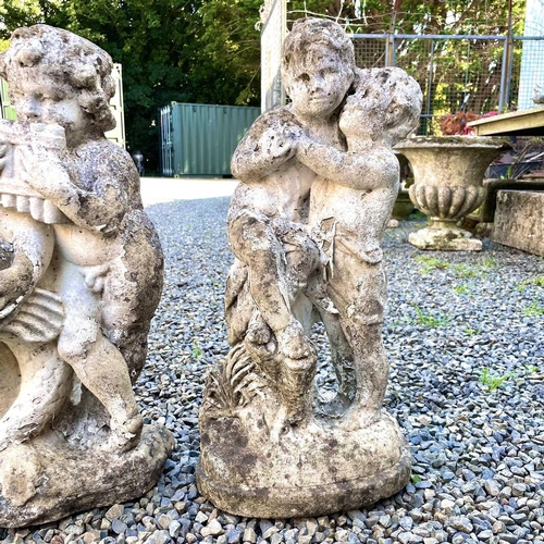 605 - A reconstituted stone fountain, modelled as putti playing pan pipes. Height 55cm together with anoth... 