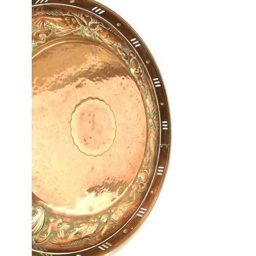 7 - A Newlyn circular copper tray. With pierced gallery and repousse decorated with a border of fish and... 