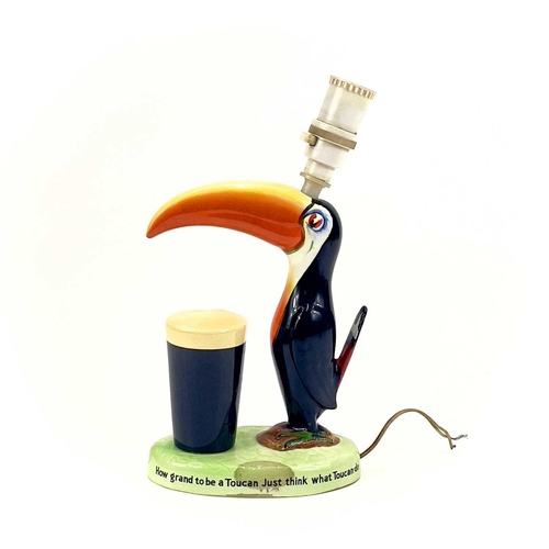 808 - A Carltonware Guinness toucan table lamp. On an oval base with printed authority mark to the base, h... 