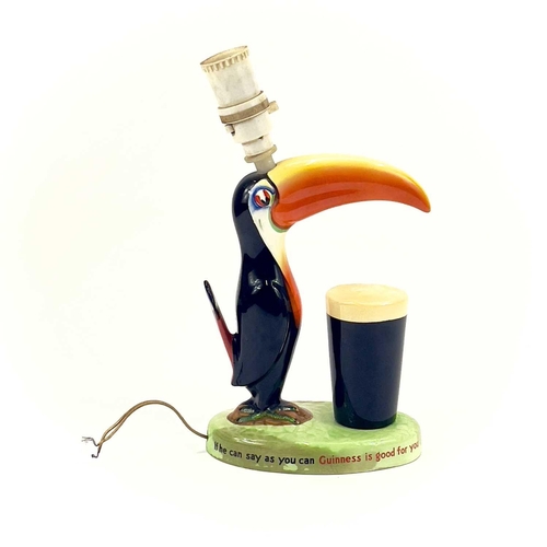 808 - A Carltonware Guinness toucan table lamp. On an oval base with printed authority mark to the base, h... 