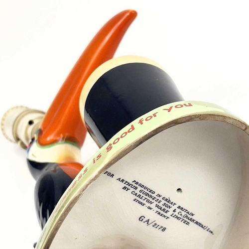 808 - A Carltonware Guinness toucan table lamp. On an oval base with printed authority mark to the base, h... 