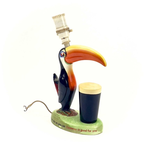 808 - A Carltonware Guinness toucan table lamp. On an oval base with printed authority mark to the base, h... 