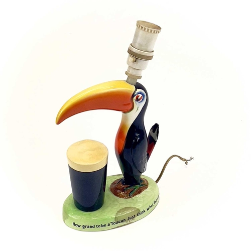 808 - A Carltonware Guinness toucan table lamp. On an oval base with printed authority mark to the base, h... 