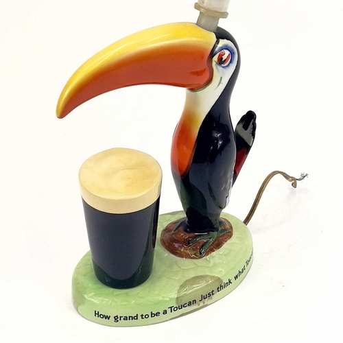 808 - A Carltonware Guinness toucan table lamp. On an oval base with printed authority mark to the base, h... 