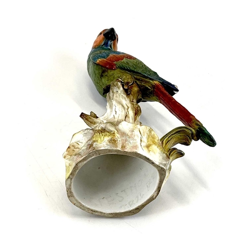 810 - A late 19th century Meissen model of a parrot perching on a branch. . Blue crossed sword marks and i... 