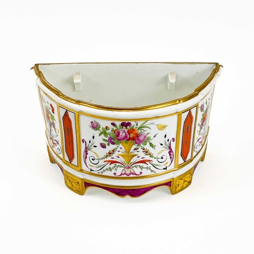 813 - A Paris porcelain bough pot. Circa 1820, polychrome painted with flower filled urns, width 24cm.