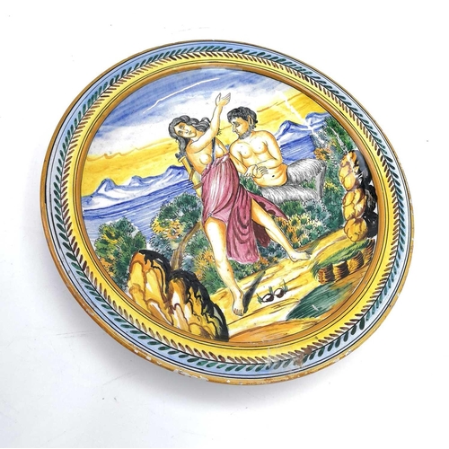 817 - An Italian Maiolica plate. Late 19th century, painted with Pan and Diana in a landscape, diameter 32... 