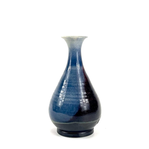 820 - Chris PRINDL A studio pottery bottle vase in a flambe glaze, signed to base, height 25.5cm.