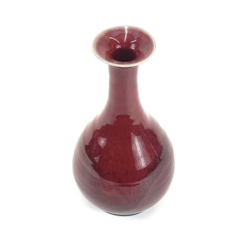 821 - Chris PRINDL A studio pottery bottle vase with an ox blood glaze, signed to base, height 26cm