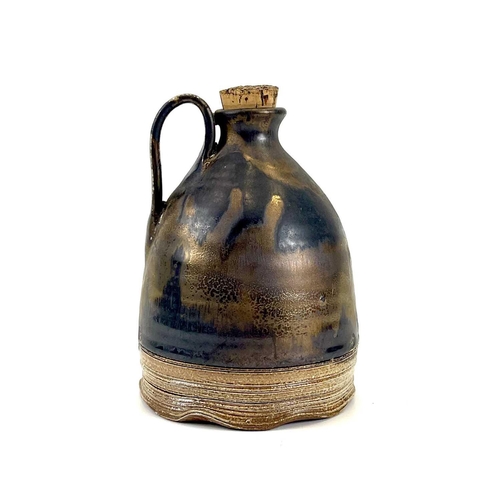 825 - Chris PRINDL A studio pottery cider jug in copper lustre glaze impressed seal mark, height 17cm.