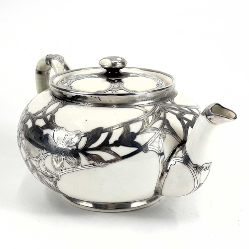 832 - A Royal Doulton white glazed silver overlaid three-piece tea service. The floral pierced and engrave... 