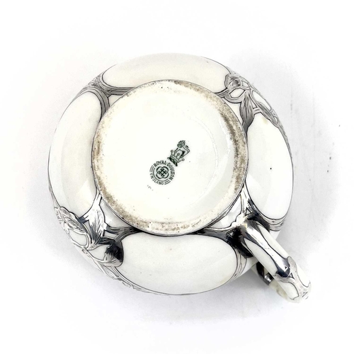 832 - A Royal Doulton white glazed silver overlaid three-piece tea service. The floral pierced and engrave... 