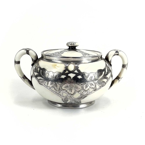 832 - A Royal Doulton white glazed silver overlaid three-piece tea service. The floral pierced and engrave... 