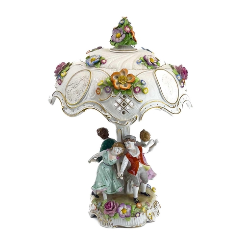 836 - A German porcelain figural flower encrusted table lamp and shade. Circa 1960s, the shade with lithop... 