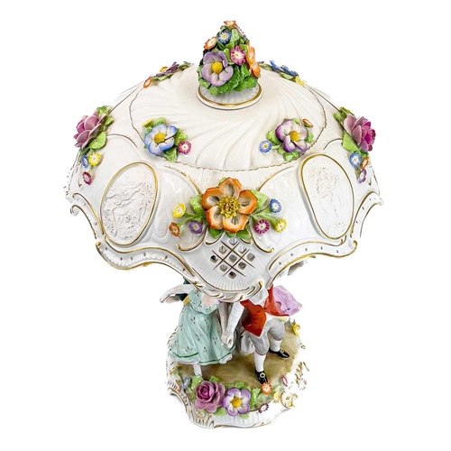 836 - A German porcelain figural flower encrusted table lamp and shade. Circa 1960s, the shade with lithop... 