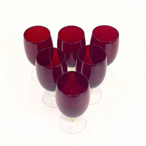 844 - A set of eight Venetian glass wine glasses. With ruby bowls and gilt flecked stems. Height 15cm.