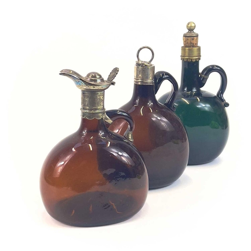 845 - A Victorian silver-mounted brown glass flask. Height 20.5cm. Together with two other similar flasks ... 