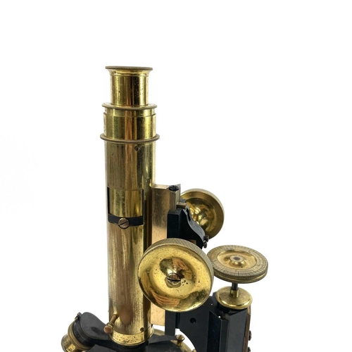 85 - A lacquered brass and brass Petrological microscope by J Swift & Sons early 20th century. Stamped U.... 