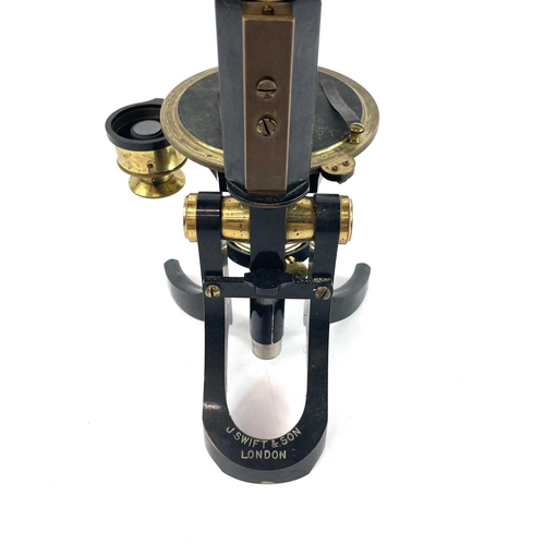 85 - A lacquered brass and brass Petrological microscope by J Swift & Sons early 20th century. Stamped U.... 