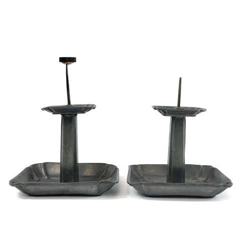 87 - A pair of Continental pewter pricket candlesticks. Late 19th century, with shaped rectangular bases,... 