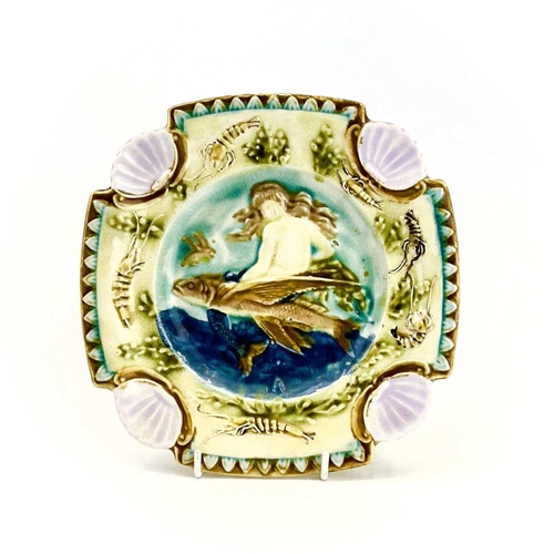 878 - A Majolica plate, French circa 1880. Relief decorated a mermaid and flying fish within a border of c... 