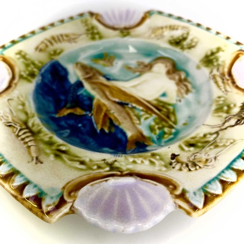 878 - A Majolica plate, French circa 1880. Relief decorated a mermaid and flying fish within a border of c... 