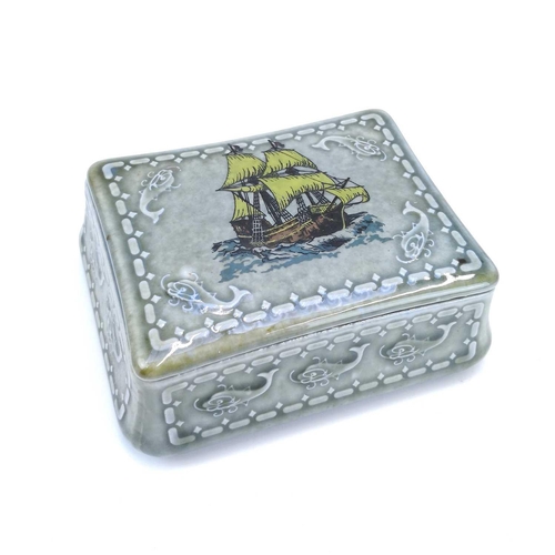 880 - A Wade Irish Porcelain Guniness trinket box and cover decorated with a full mast ship and whales. Th... 