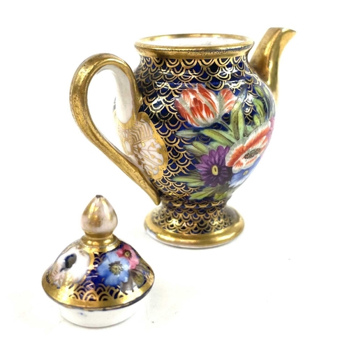 887 - A Spode porcelain miniature coffee pot and cover finely decorated with bouquets of flowers. Height 5... 