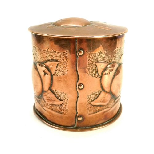 9 - A Newlyn copper cylindrical tea caddy and cover. Repousse decorated with medlars on a punched ground... 