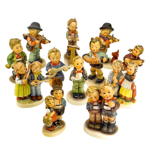 900 - A collection of twelve Hummel porcelain figures. Including Happiness, Surprise, Vocalist amongst oth... 