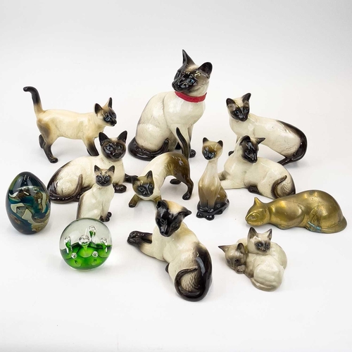 903 - Beswick pottery Siamese cats. A clowder of Beswick pottery cats, together with a brass model of a ca... 