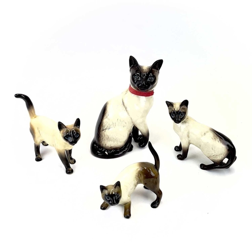 903 - Beswick pottery Siamese cats. A clowder of Beswick pottery cats, together with a brass model of a ca... 