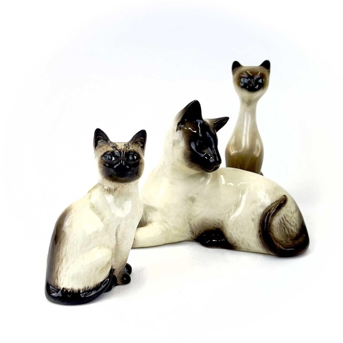 903 - Beswick pottery Siamese cats. A clowder of Beswick pottery cats, together with a brass model of a ca... 