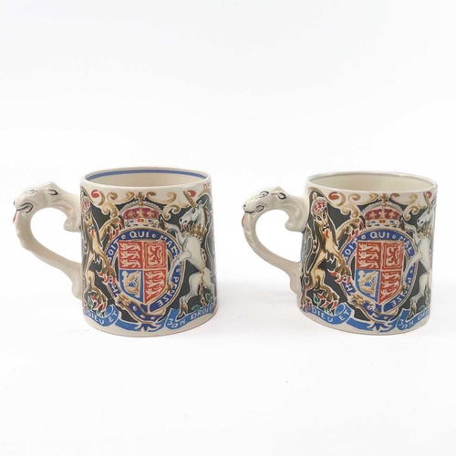 911 - A King George V coronation mug designed and modelled by Dame Laura Knight. Height 8cm together with ... 