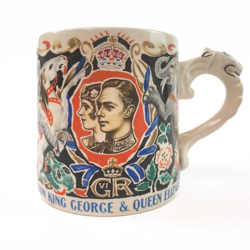 911 - A King George V coronation mug designed and modelled by Dame Laura Knight. Height 8cm together with ... 