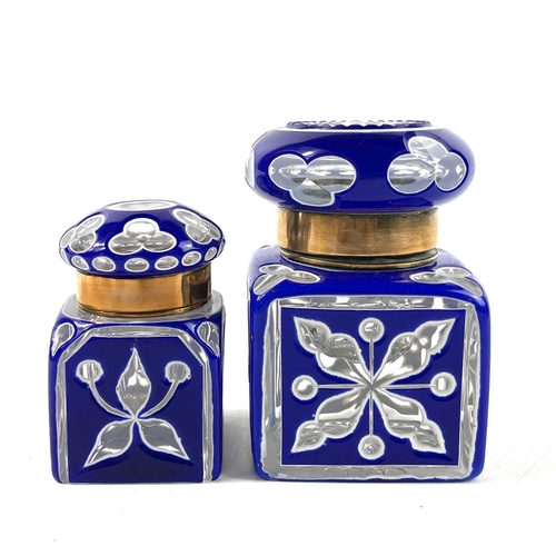 919 - A Bohemian heavy blue and white overlay glass inkwell. With hinged cover and floral and club cut dec... 