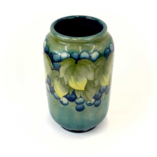 929 - A Moorcroft 'Leaf and Berry' pattern vase. Signed and impressed marks to base. Height 22cm.