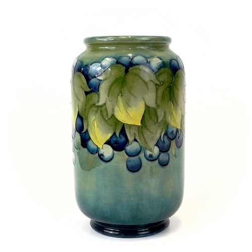 929 - A Moorcroft 'Leaf and Berry' pattern vase. Signed and impressed marks to base. Height 22cm.