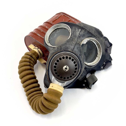 95 - A WWII British No.4 III gas mask. Together with a steel helmet and WWII webbing belt and harness.